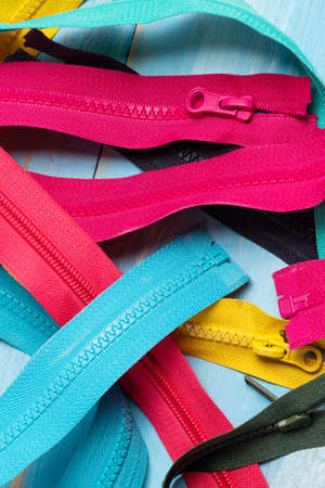 Pack lot of colorful plastic and metal zippers stripes with sliders pattern for handmade sewing...