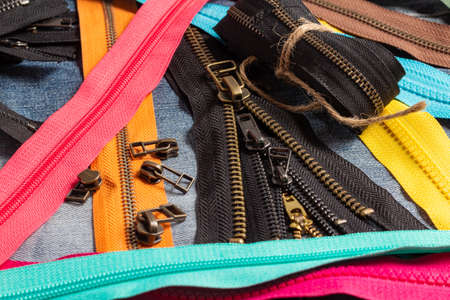 Pack a lot of colorful plastic and metal zippers stripes with sliders pattern for handmade sewing...