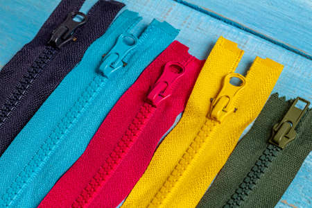 Pack lot of colorful plastic and metal zippers stripes with sliders pattern for handmade sewing...