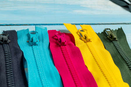 Pack a lot of colorful plastic zippers stripes with sliders pattern for handmade sewing tailoring on...
