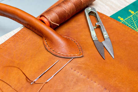 Sewing brown leather bag. Leather craft process.