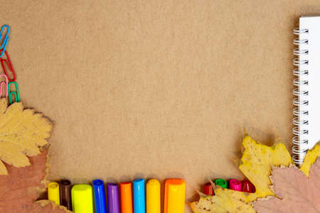 composition with notebook blank page colorful pencil, marker and pen mock-up Back to school concept with stationery office supplies on a craft cardboard backgroundの写真素材