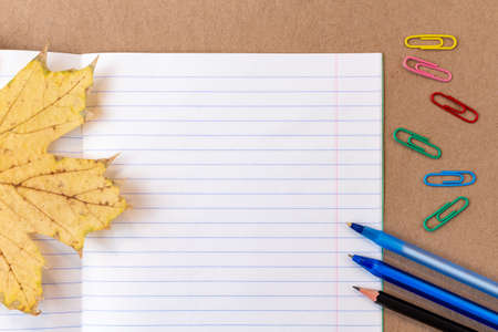 composition with notebook blank page colorful pencil, marker and pen mock-up Back to school concept with stationery office supplies on a craft cardboard backgroundの写真素材