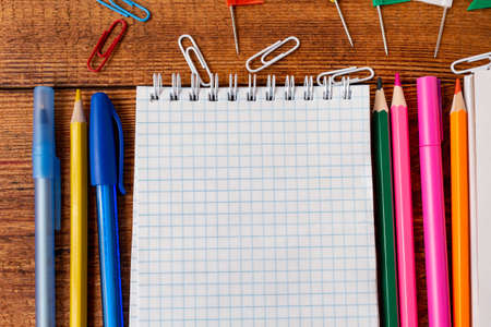 composition with notebook blank page colorful pencil, marker and pen mock-up Back to school concept