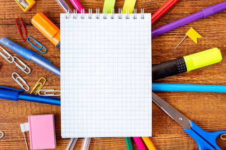 composition with notebook blank page colorful pencil, marker and pen mock-up Back to school concept