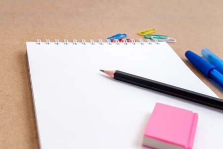 composition with notebook blank page colorful pencil, marker and pen mock-up Back to school concept...