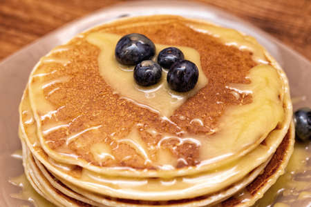 Pancakes on the brown wooden backgroundの写真素材