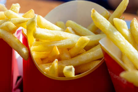 Eating fast food French fries potatoes, unhealthy fast food. Calories fat.