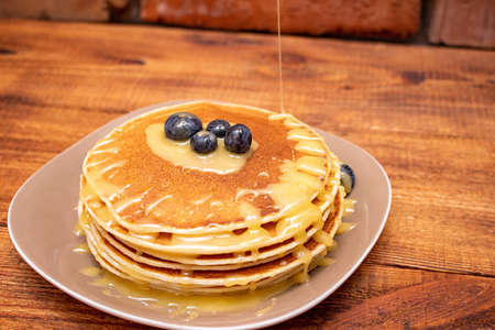 Pancakes on the brown wooden background
