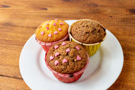 delicious cupcakes with heart-shaped confectionery