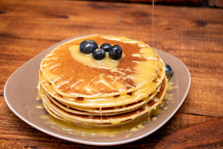 Pancakes on the brown wooden backgroundの写真素材