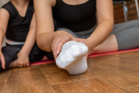 woman doing yoga stretching at home close up