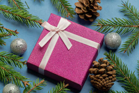 Gift box with Christmas tree toys, green fir, spruce branchesの写真素材