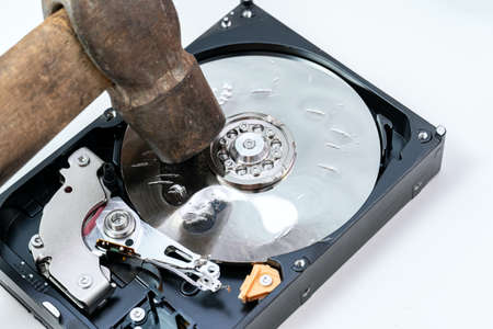 Destruction, deleting of data, information on a hard disk drive with hammerの写真素材