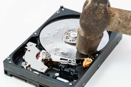 Destruction, deleting of data, information on a hard disk drive with hammerの写真素材