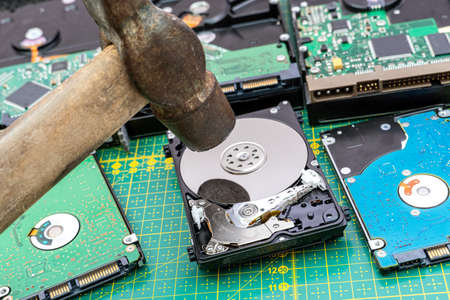 Destruction, deleting of data, information on a hard disk drive with hammerの写真素材