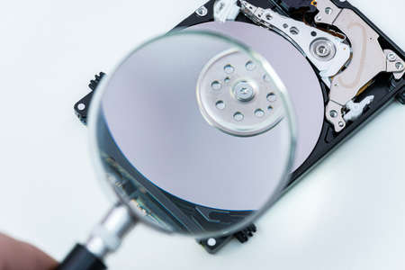 hard disk drive through a magnifying glass, information search, diagnostics, restore