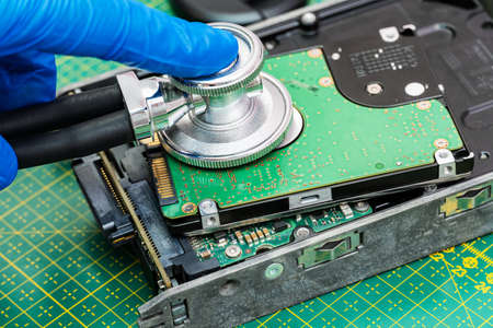 hard drive diagnostics with a stethoscope. Recovery, search lost data, information in hdd repair serviceの写真素材