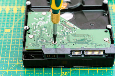 hard disk drive disassembling process with screwdriver in information recovery, repair HDD serviceの写真素材
