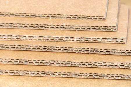 Stack of cardboard for packaging with cells close up as background