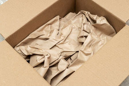 Open cardboard box full of wrapping paper close up