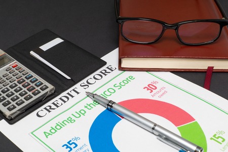 Credit score report with keyboard and notepad.