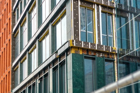 Construction of a residential frame house made of clay bricks and glass.の写真素材