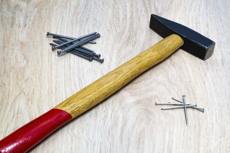 Range of tools on wood hammer, nails on the table.の写真素材