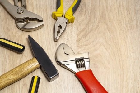 Useful sets of tools for the home, all the tools on a wooden table.