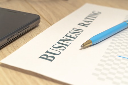 Business financial rating chart with pen, bank cards and calculator on desk.の写真素材