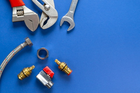 A set of tools for plumbing, isolated on a blue background with space for advertising.の写真素材