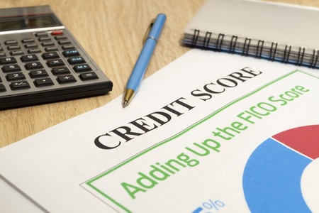 Credit score report with calculator, notebook and pen on a table.の写真素材