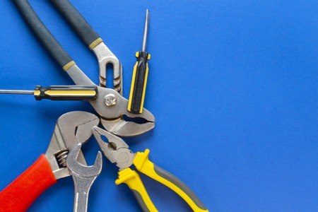 A set of tools for plumbing, isolated on a blue background with space for advertising.の写真素材
