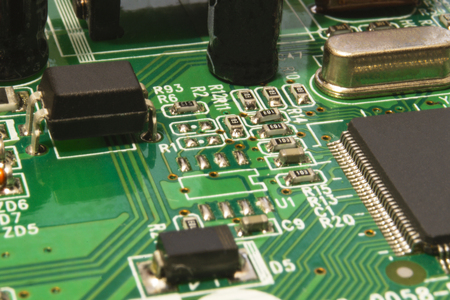 Close up on electronic board in hardware repair shop, blurred and toned image.の写真素材