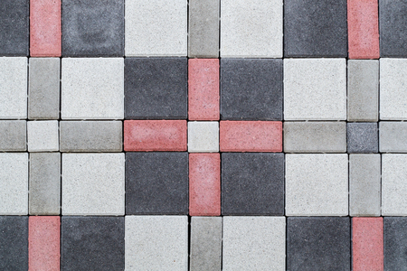 Texture of paving bricks of different colors. Facing material under imitation of a brick wall for construction. Example at the exhibition.の写真素材