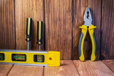 Hand tool on dark wooden background for homework. Kit for household works or for a locksmith.の写真素材