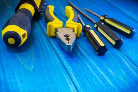 Hand tool on blue wooden background for homework. Kit for household works or for a locksmith.の写真素材