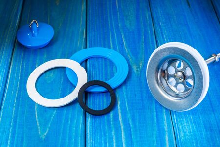 Accessories for plumbing repairs or washing in the kitchen on a wooden vintage background.の写真素材