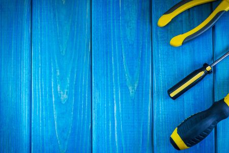 Hand tool on blue wooden background for homework. Kit for household works or for a locksmith.の写真素材