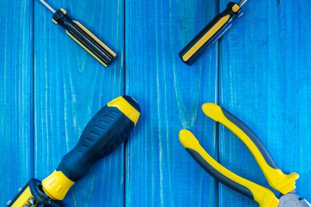 Hand tool on blue wooden background for homework. Kit for household works or for a locksmith.の写真素材