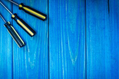 Hand tool on blue wooden background for homework. Kit for household works or for a locksmith.の写真素材