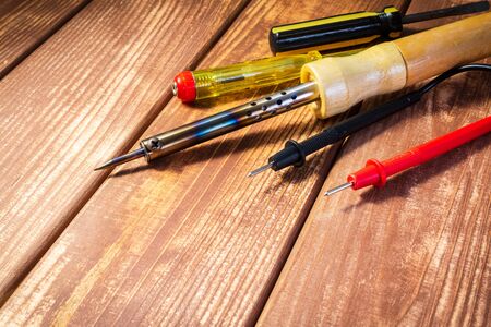 A set of tools for servicing electronics, on vintage wooden background.の写真素材