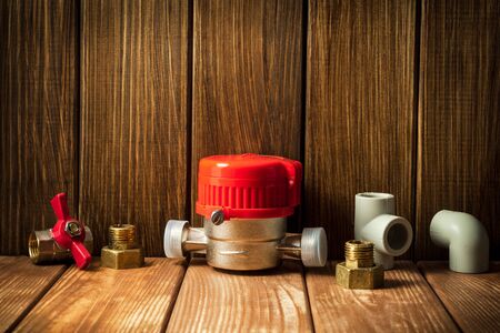 New water meter with fittings on a vintage woodenの写真素材