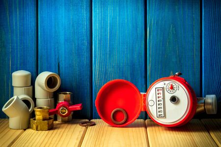 New water meter with fittings on a vintage woodenの写真素材
