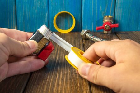 Work combines elements of plumbing with the help of tools. Wooden background