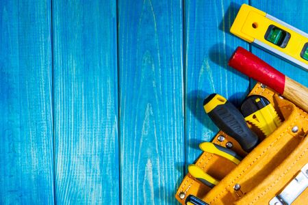A necessary set of tools in a bag on a blue woodenの写真素材