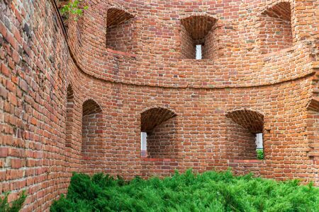 Remains of an old fortress in Poznan city, Poland. View of the wall with loopholes.の写真素材