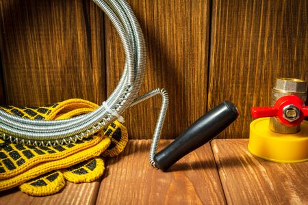 Accessories for plumbing repairs or washing in the kitchen on a wooden vintageの写真素材