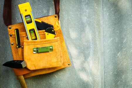 Tools in a bag for homework hang on an old cipher board. Set for the master.の写真素材