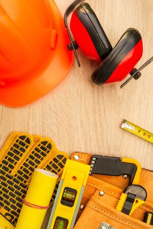 Protective equipment and tools in a bag for the builder on a woodenの写真素材